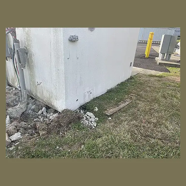 Each side of the structure was inspected to ensure the base was still intact with the foundation. Corner of the mobile home with soil and concrete exposed as Next Day Demolition staff double checks the foundation.