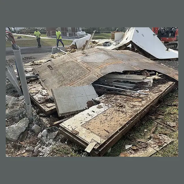 Collapsed mobile home structure with debris scattered, demolished by Next Day Demolition.